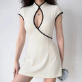 Model wearing white cheongsam-style dress with keyhole neckline and black trim, form-fitting mini dress
