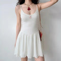Model wearing white knit eyelet spaghetti-strap mini dress with ruffle hem, casual feminine summer dress