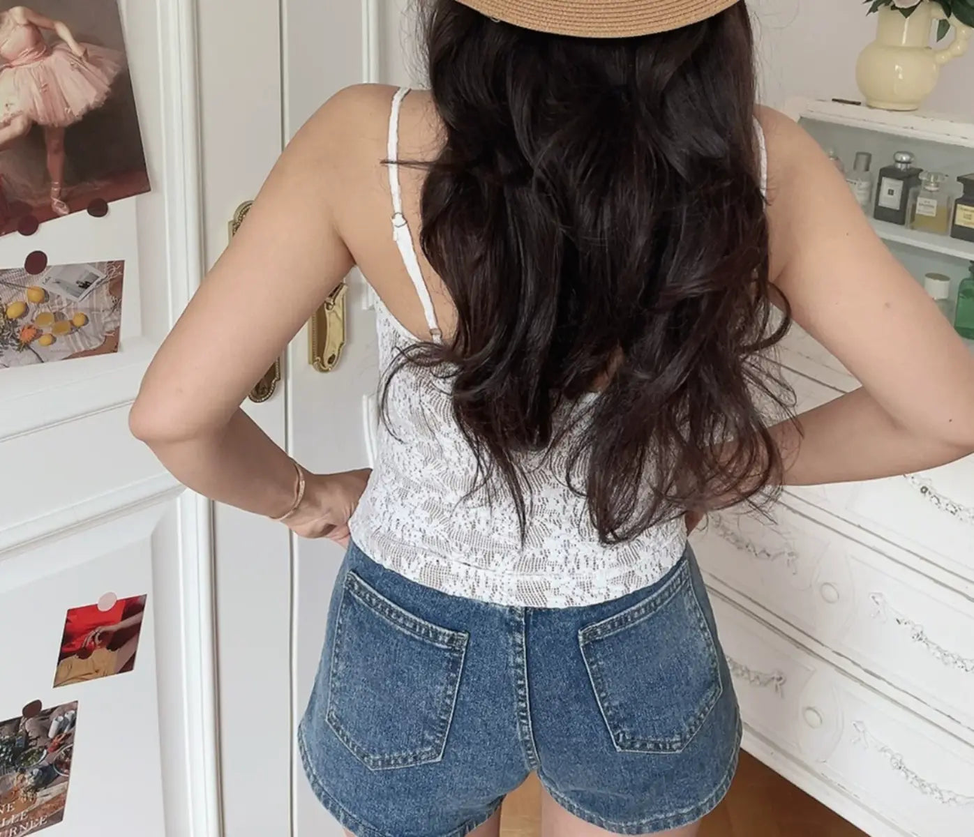 Back view of white lace cami top with thin straps and fitted corset-style back panel