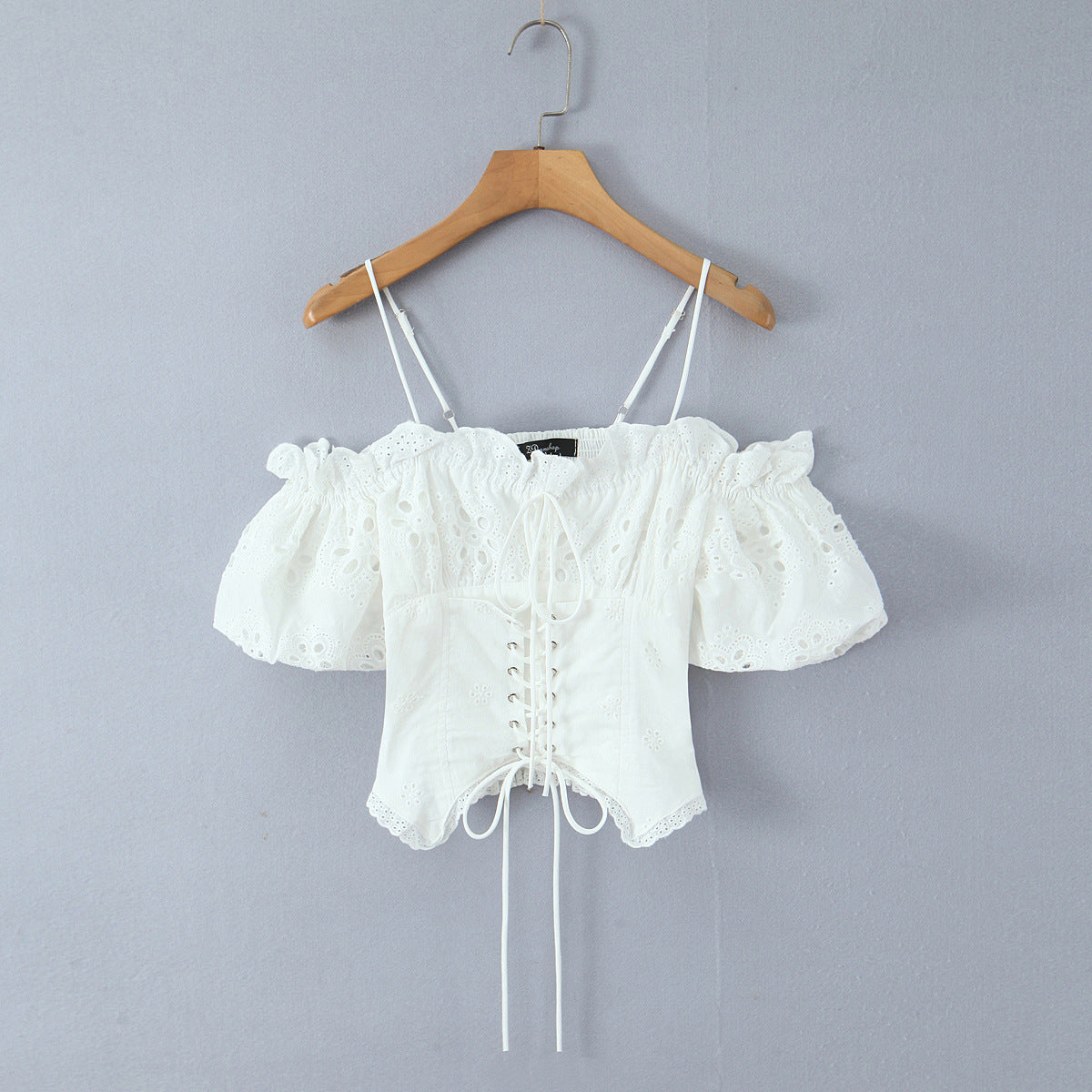 Front hang view white lace eyelet embroidery off shoulder puff sleeve lace up front corset slim crop top, elegant romantic vintage blouse
