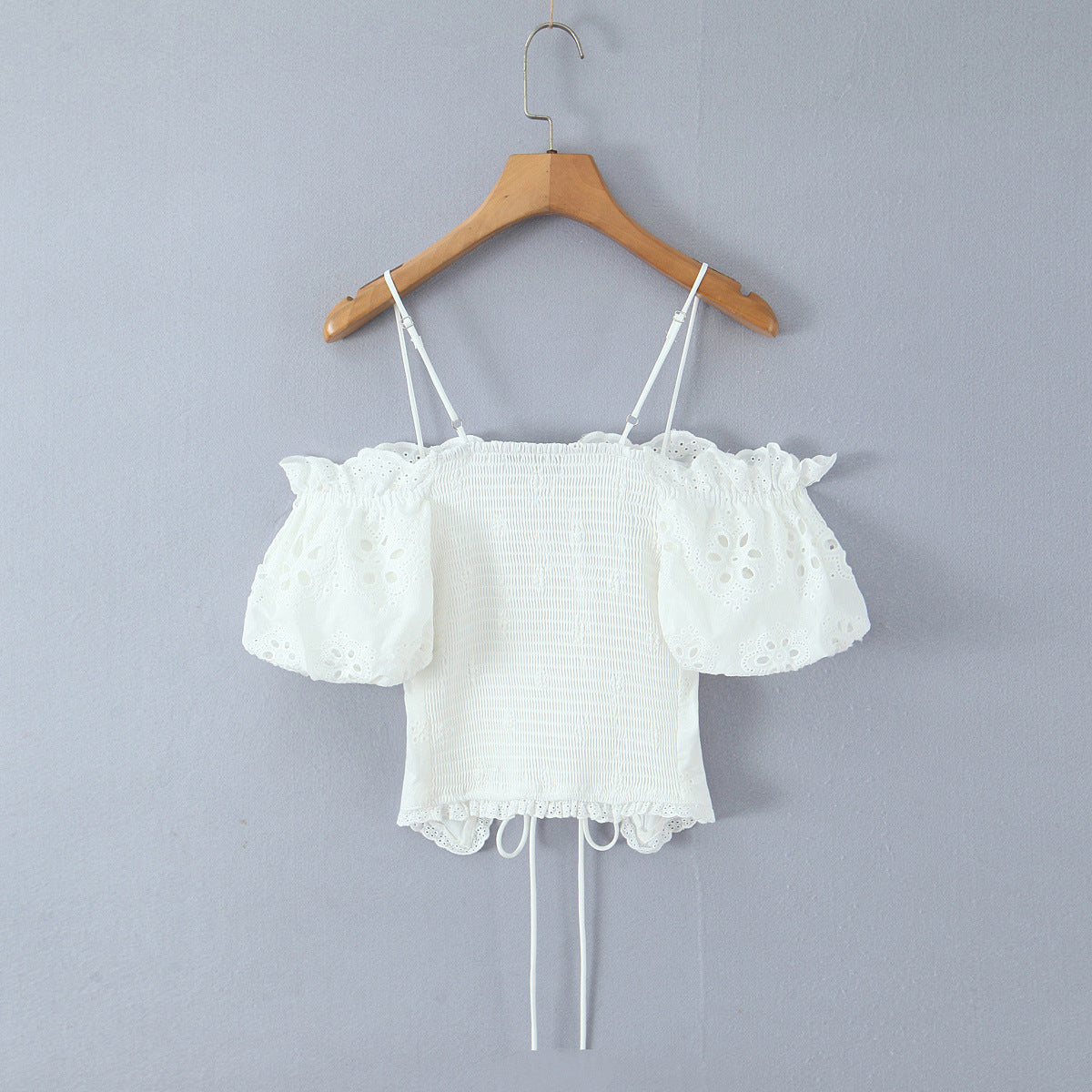 Back hang view white hollow out lace embroidery off shoulder smocked back adjustable strap corset crop top, elegant romantic vintage blouse