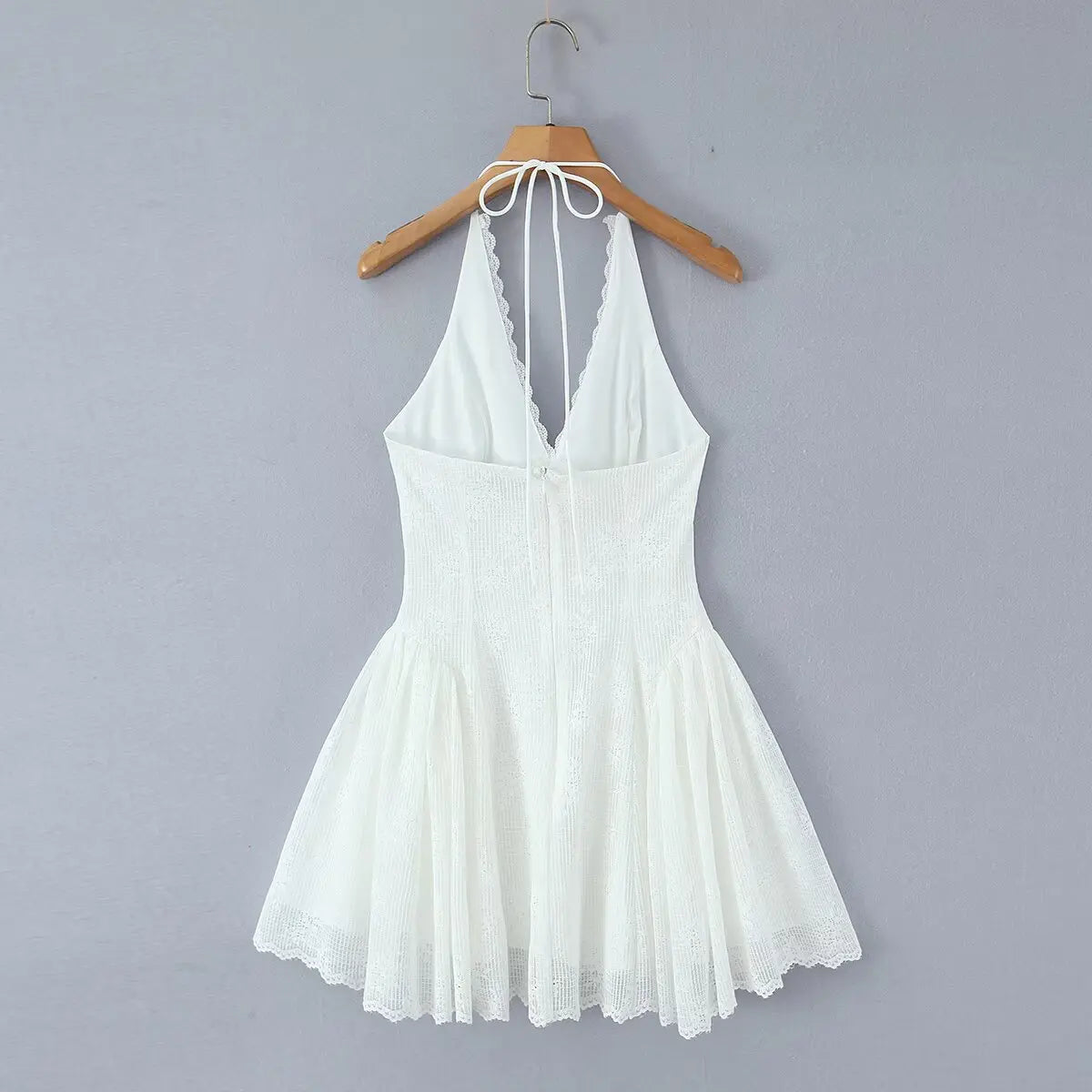 White lace halter mini dress, back view on white background
