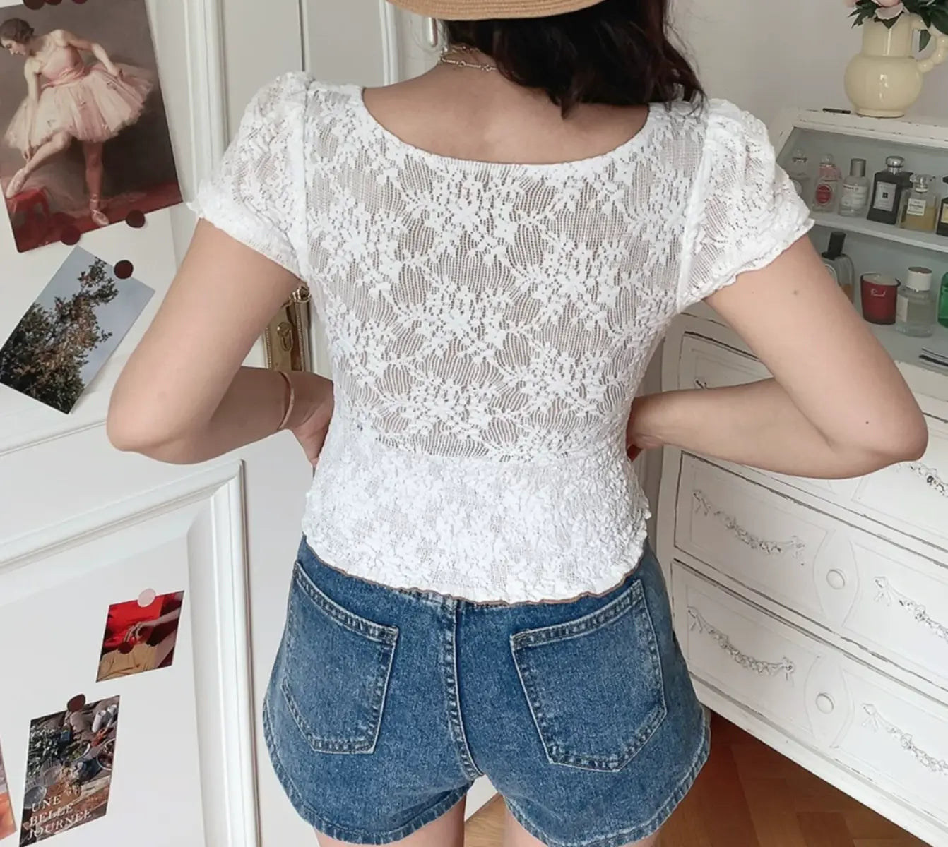 Back view of white lace top with smocked elasticated waistband and short puff sleeves