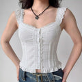 Model wearing white lace-trim ruffle-strap cropped camisole with button front, feminine vintage-inspired top
