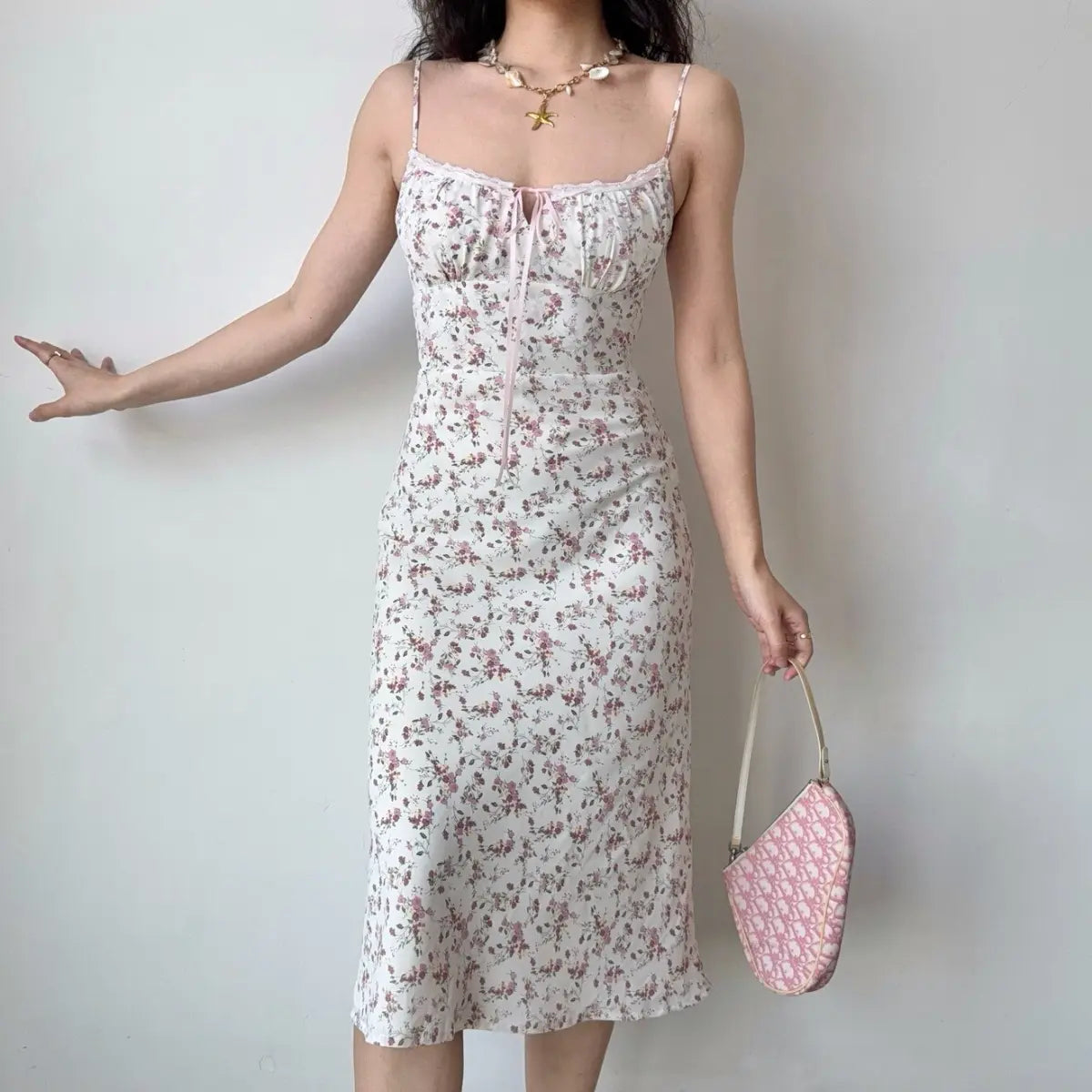 Model in white pink ditsy floral midi dress, front view