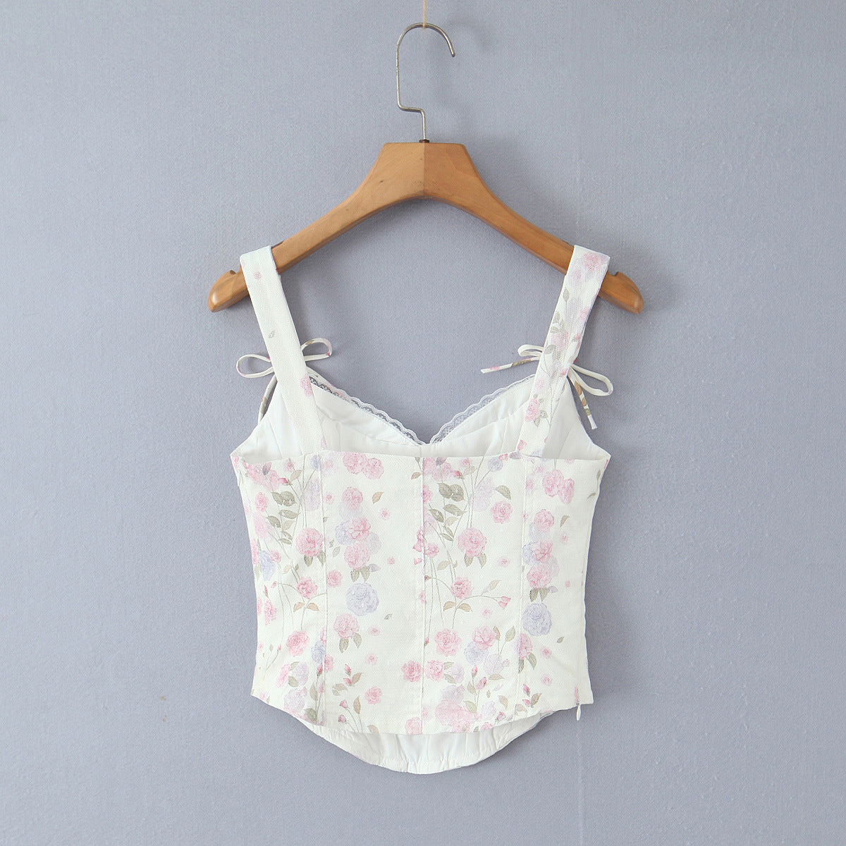 Back hang view white floral lace trim bow strap corset zip back slim fitted crop cami top, elegant romantic vintage blouse