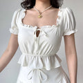 White off-shoulder peplum top with ruffled sleeves