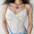 Model in white ruffled cami corset top, front view