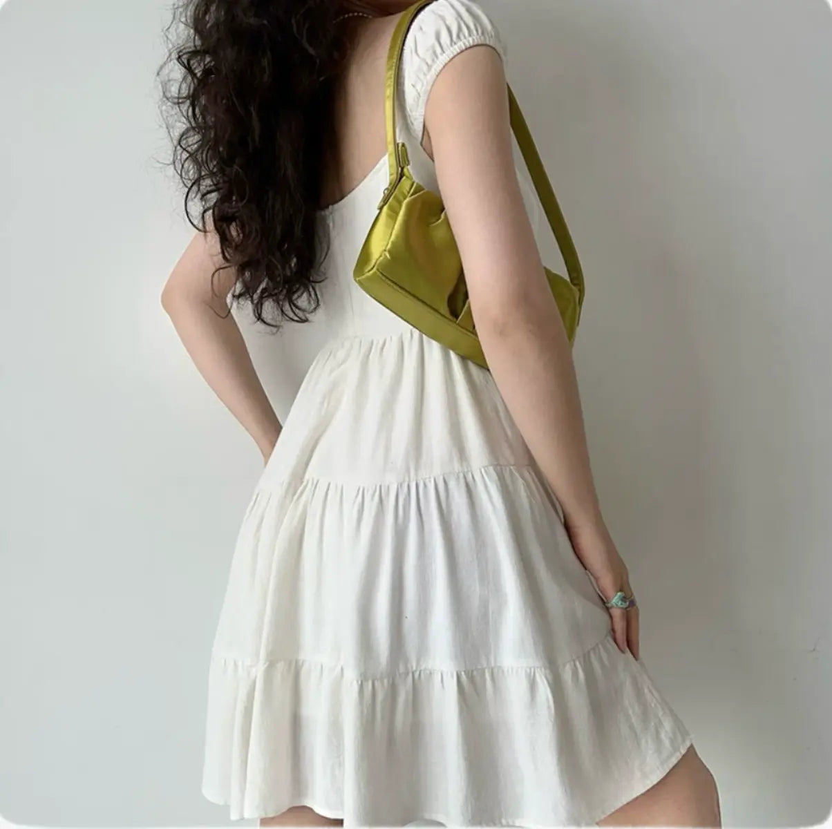 Back-side view of white tiered mini dress