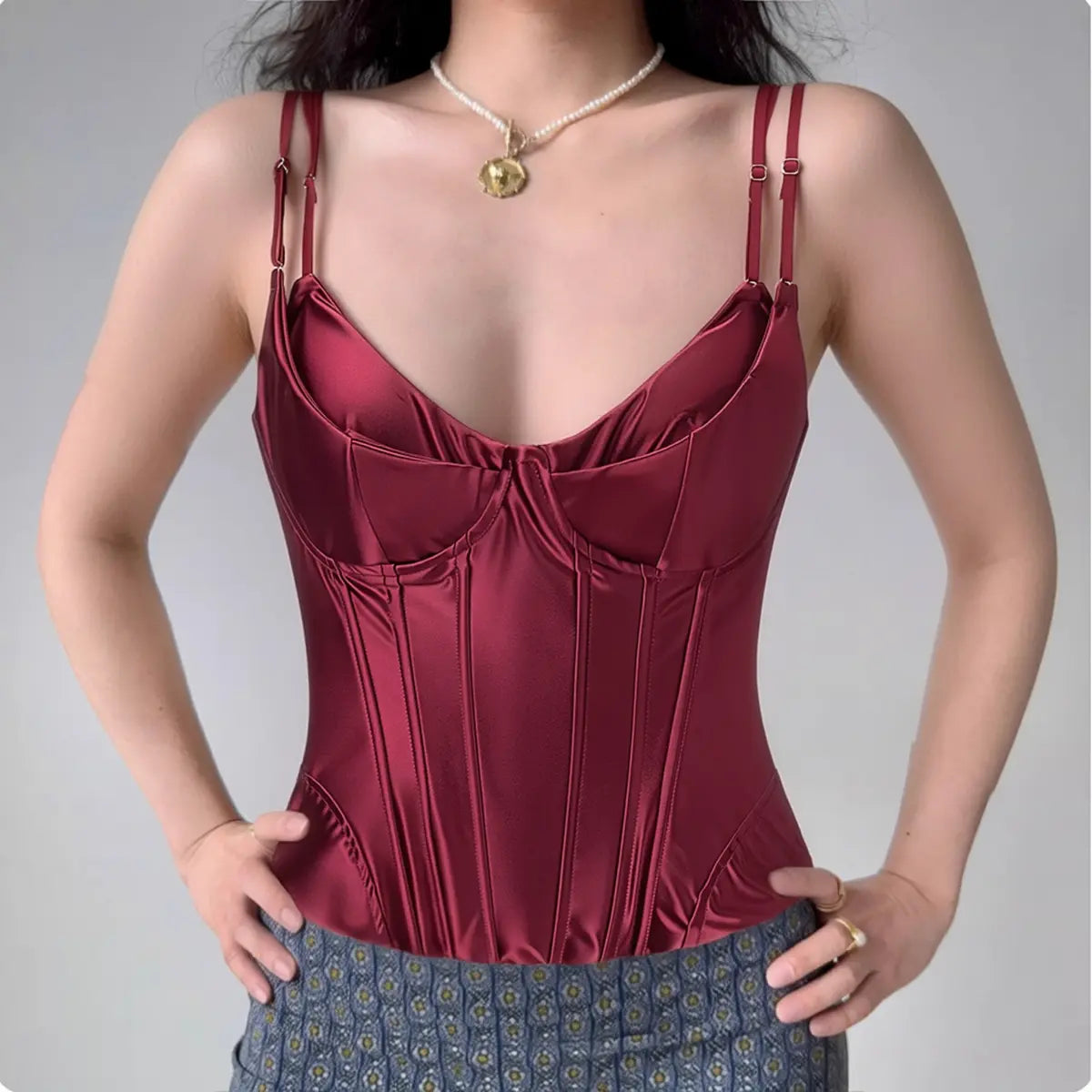 Model wearing wine red satin corset-style spaghetti-strap top with double straps, bustier cami