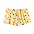 Front view of yellow black polka dot balloon shorts with elastic waist