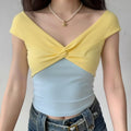 Model wearing yellow blue two-tone knit top with twist-front V-neck, cropped fitted cami