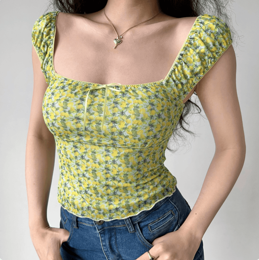 Full front view yellow green floral print square neck puff short sleeve crop top, tie front ruffle hem slim casual vintage blouse