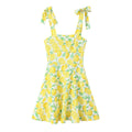 Front view of yellow lemon print cami mini dress with tie shoulder straps and A-line silhouette
