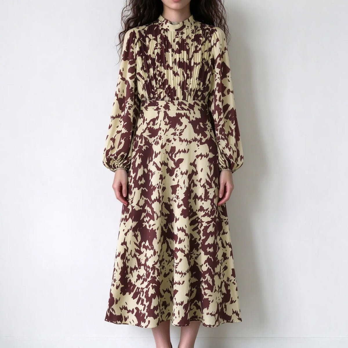 Model wearing abstract animal print pleated bodice midi dress, front view