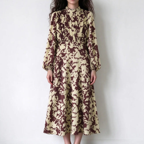 Model wearing abstract animal print pleated bodice midi dress, front view