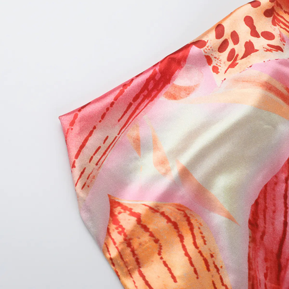 View of a dress panel with the abstract print, showing the color-blocking and satin sheen