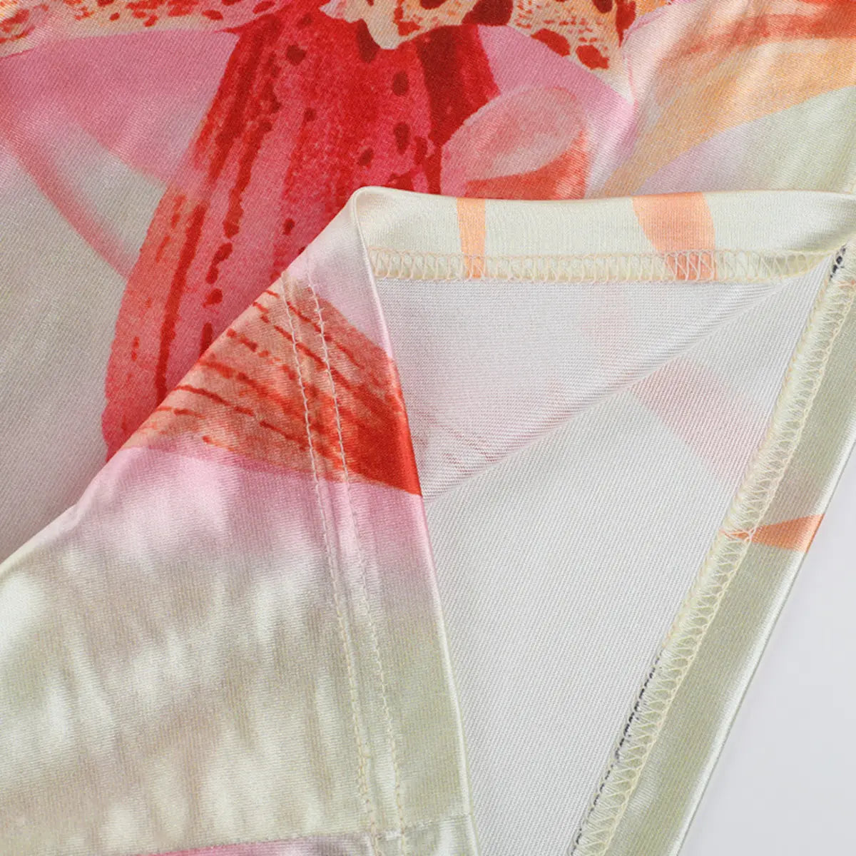 Close-up of the dress seam, showing the neat stitching and folded satin hem