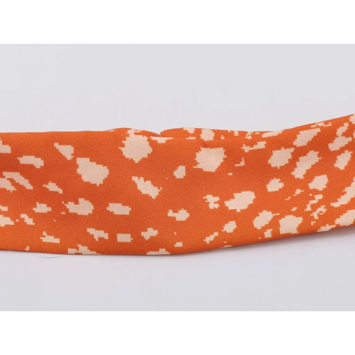 Close-up of separate matching fabric choker for orange abstract speckled print maxi dress