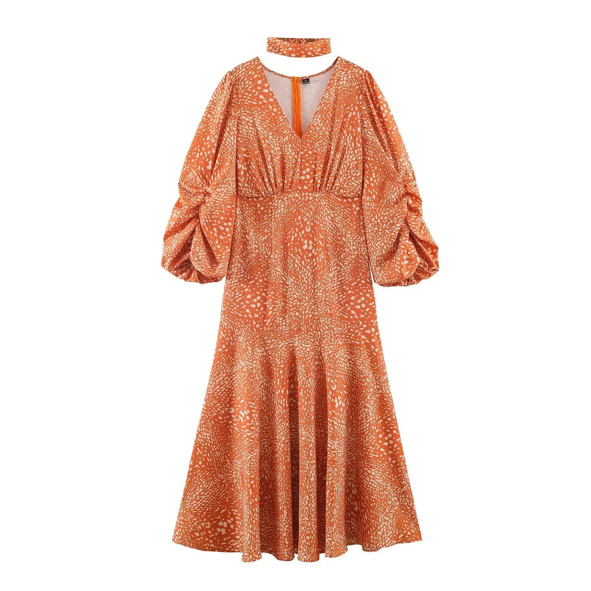 Front view of abstract print maxi dress, orange base with off-white speckled pattern, v neck, puff long sleeves, matching choker accessory