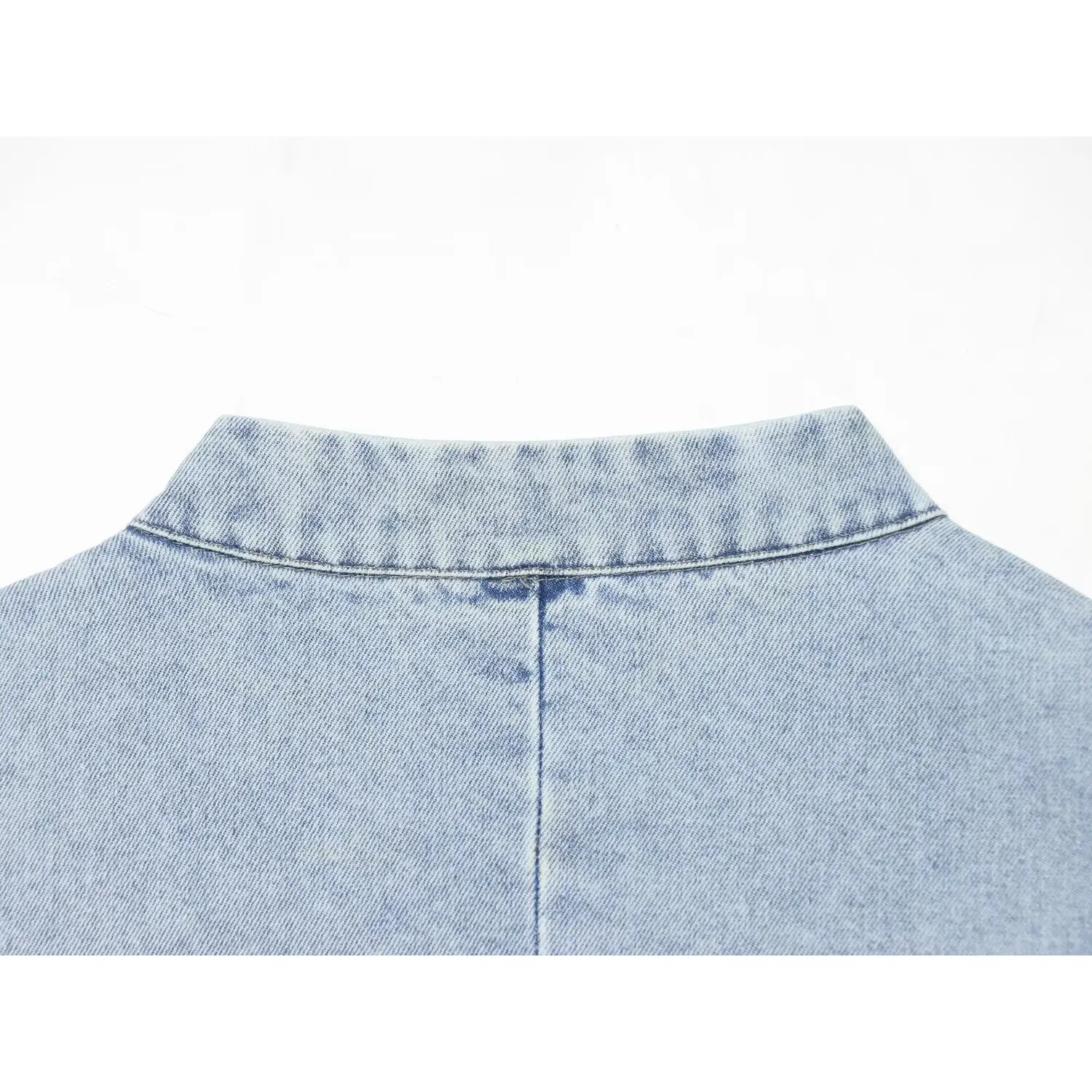 Flat closeup rear stand collar & center back seam on light wash denim peplum waistcoat
