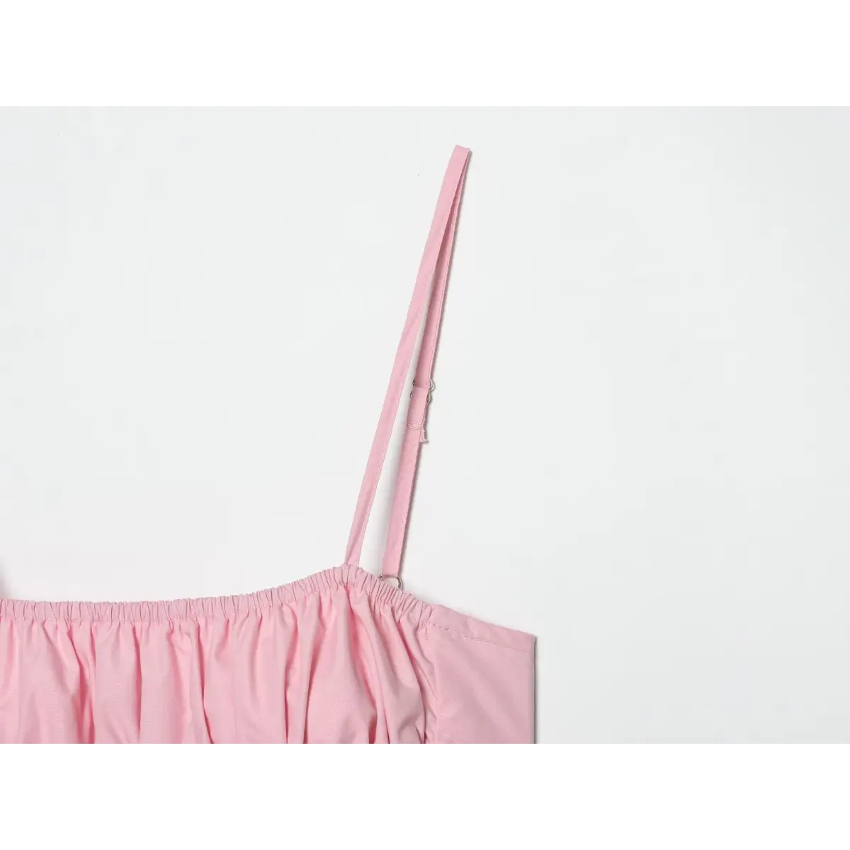 Close of thin matching pink adjustable strap with silver metal slider, elastic shirred bust edge detail.