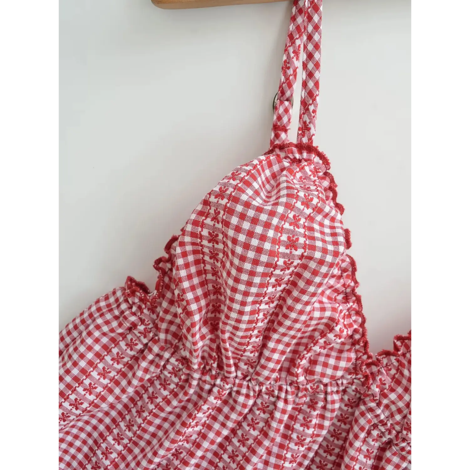 Adjustable thin printed strap red gingham cami top flat detail, matching fabric buckle straps scalloped v-neck edge chiffon fabric white background shot
