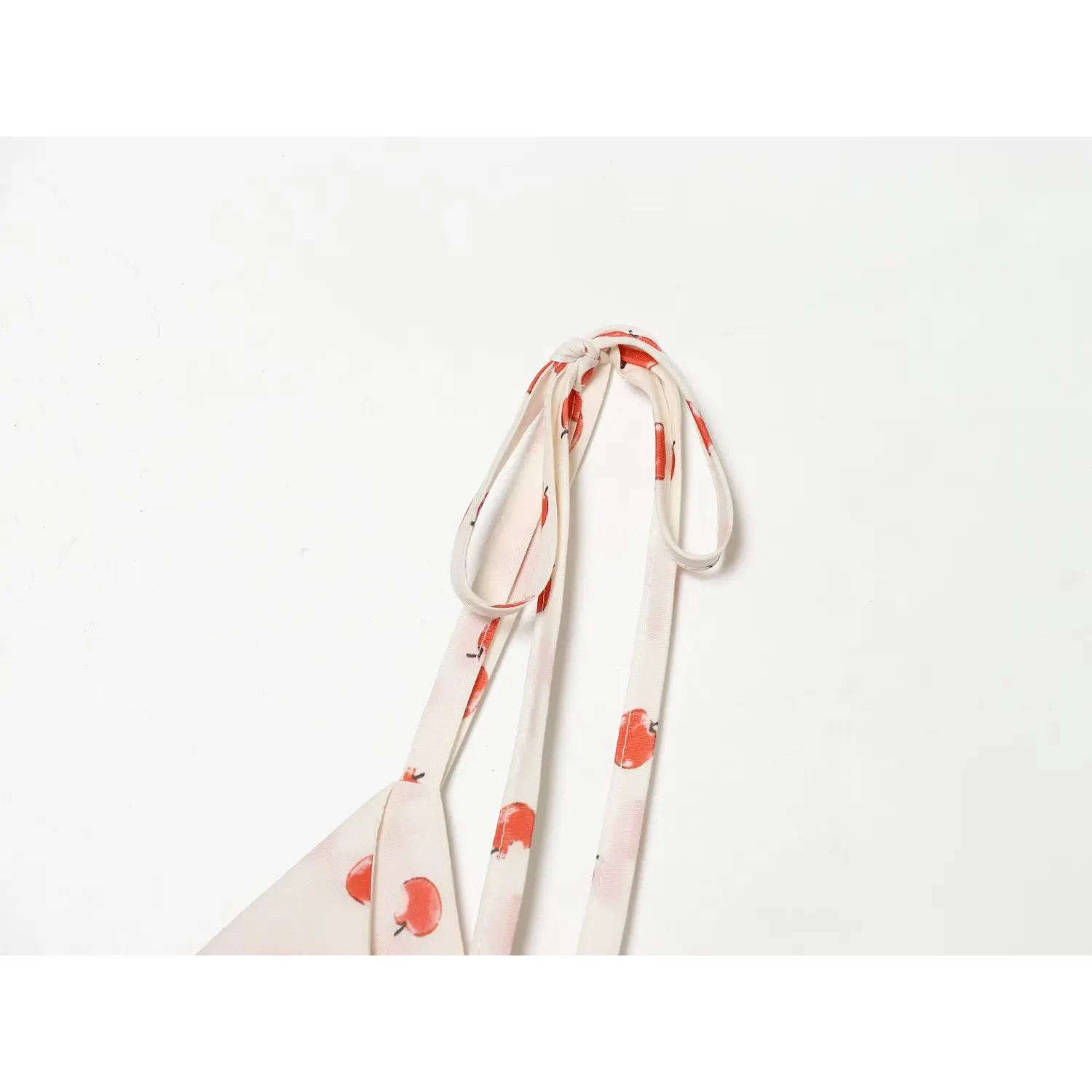 Adjustable tie strap nightdress macro flat close-up, extended self tie straps free length adjust apple print woven strap sewing detail shot