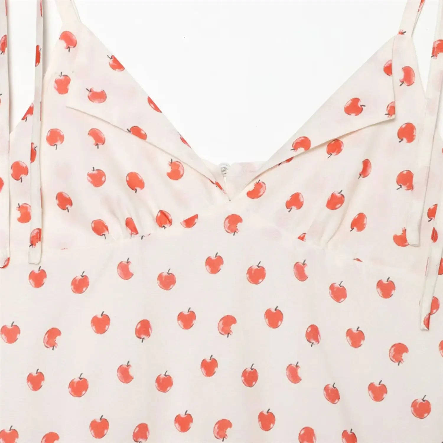 Bust section closeup folded lapel V neck, tailored bust dart shaping, natural soft drape cream apple print fabric