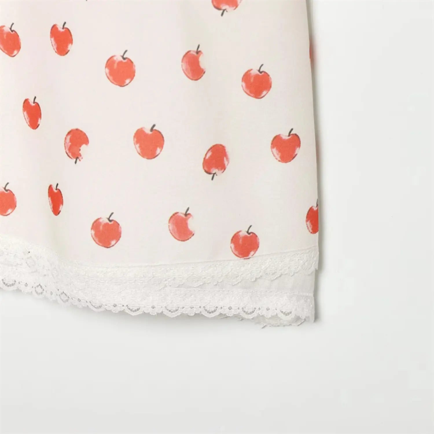 Side skirt hem closeup double layer lace trim, soft flowing apple print fabric, neat finished side seam stitching