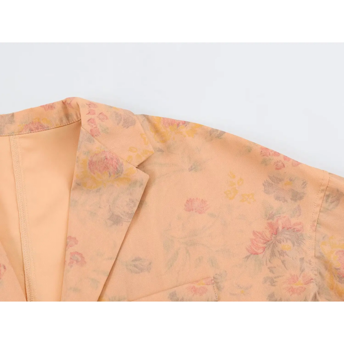Close-up of lapel corner and floral print on shoulder