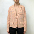 Model wearing apricot floral print cropped blazer with black trousers