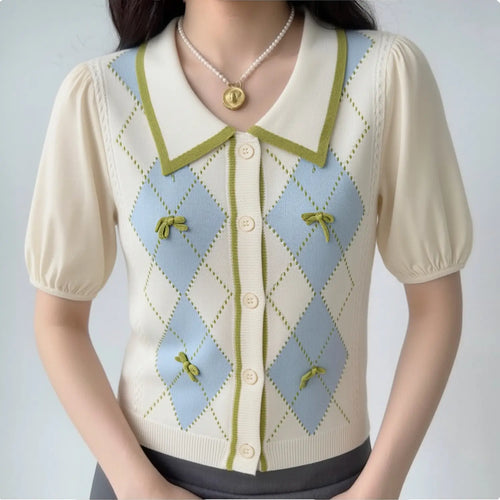 Model wearing preppy college argyle knit mixed sleeve blouse, green trim lapel collar, mini fabric bow diamond print, cream bubble short sleeves, casual daily sweet outfit with pearl necklace