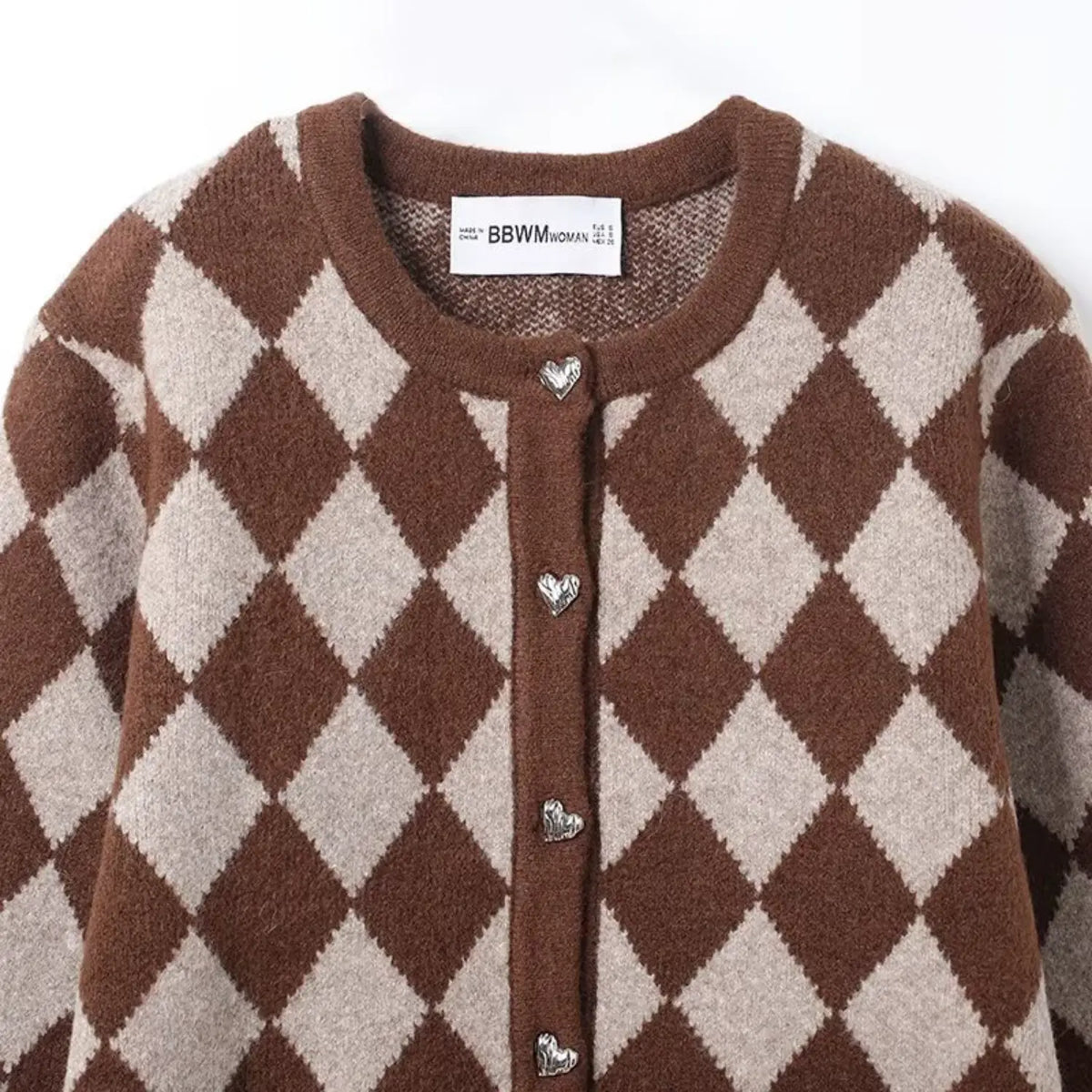 Close-up of round neck and heart buttons