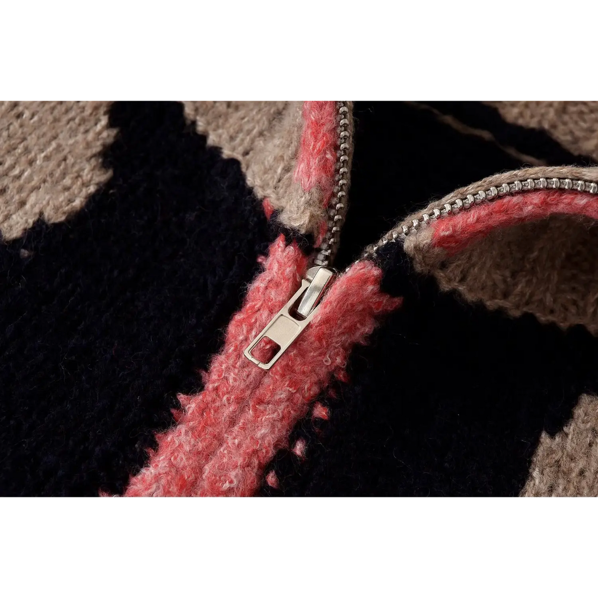 Close-up of metal zipper pull and pink placket