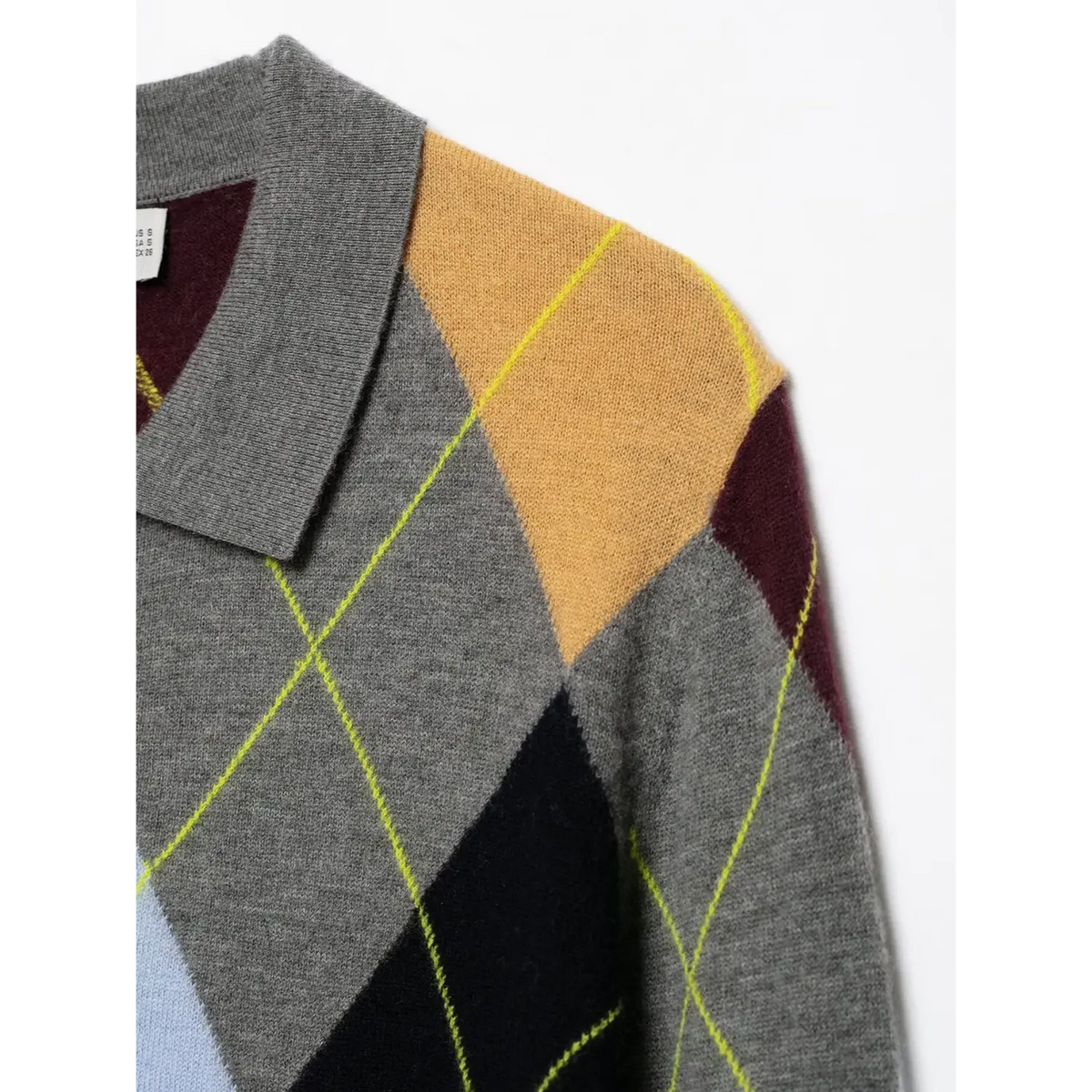 Close-up of grey polo collar and white size label inside argyle knit sweater
