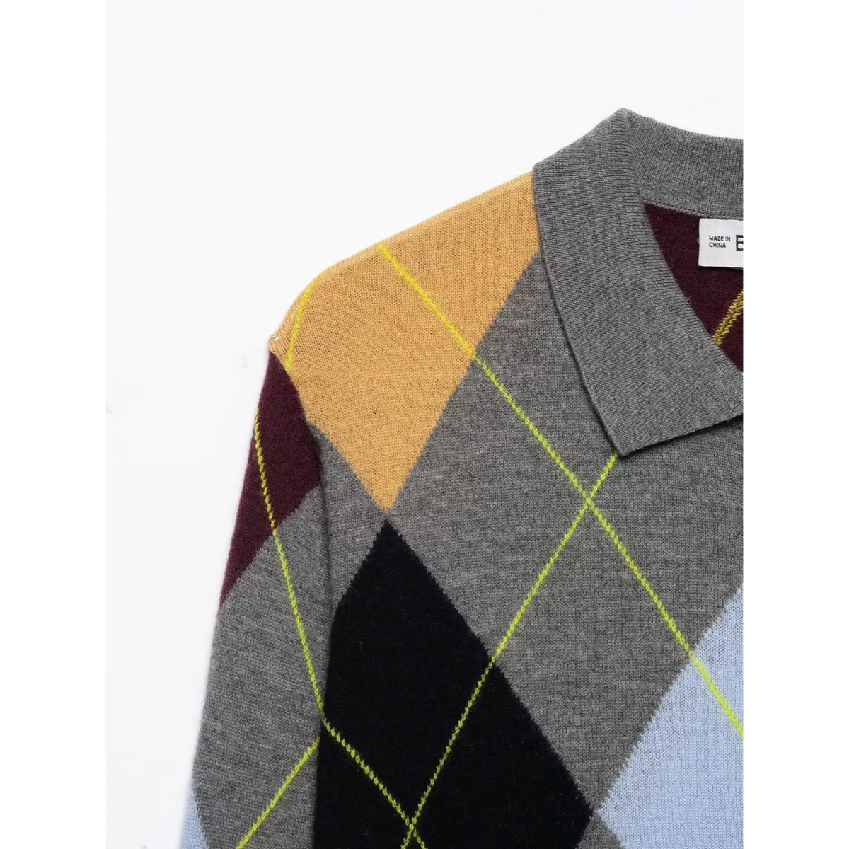 Close-up of grey polo collar and shoulder on argyle diamond knit sweater