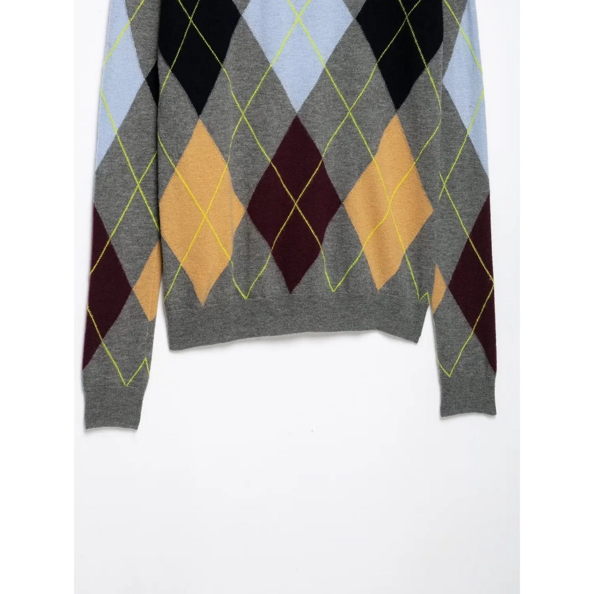 Close-up of grey ribbed hem and cuffs on argyle diamond knit sweater