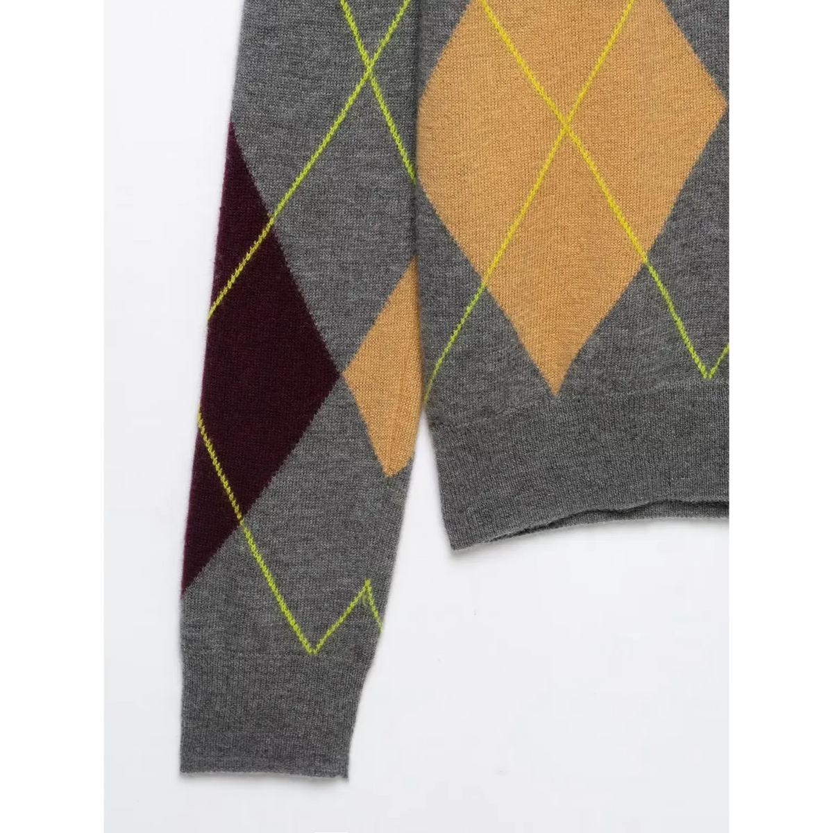 Close-up of sleeve and bodice seam on grey argyle knit with yellow-green outlines