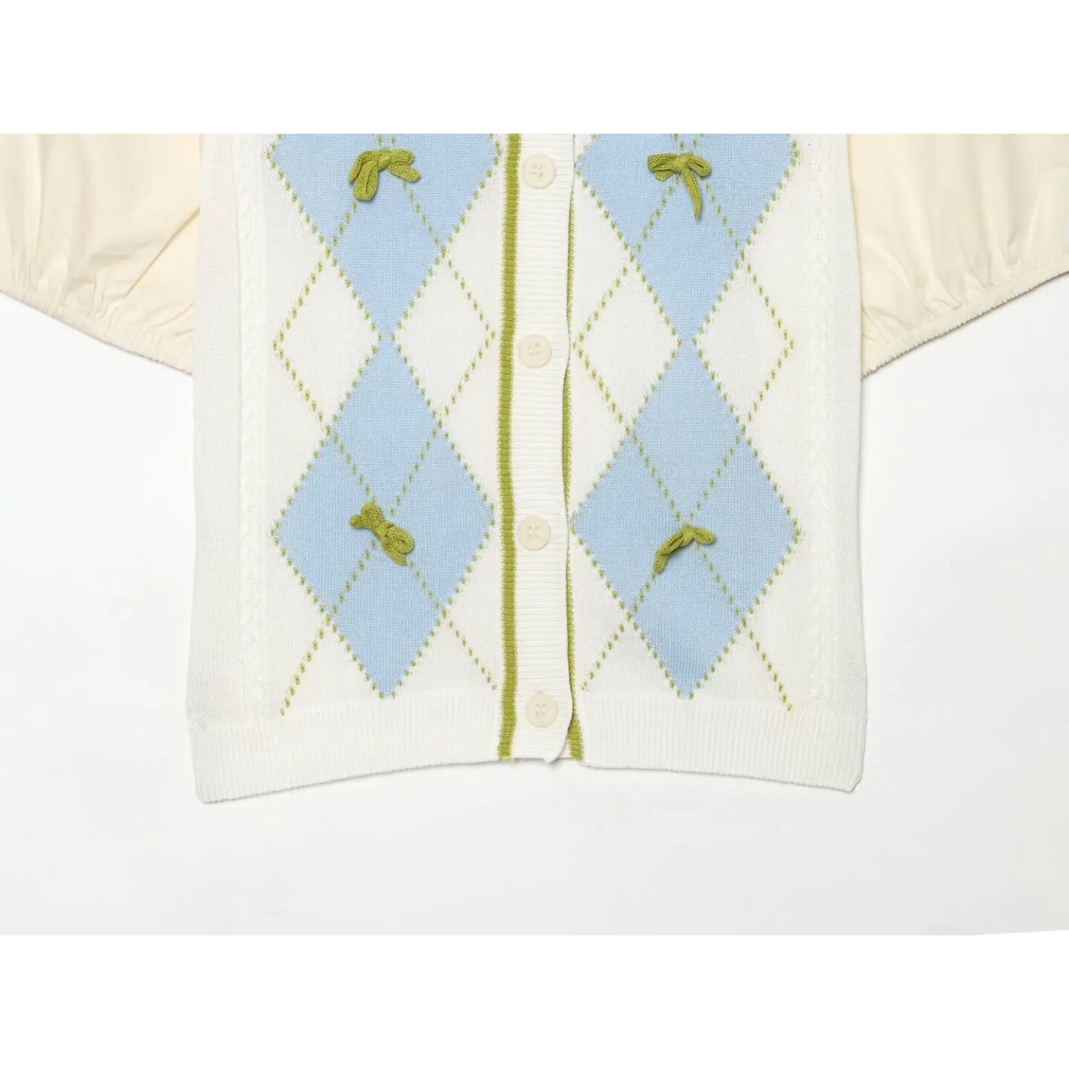 Wide shot full front panel of argyle knit blouse, evenly distributed mini green fabric bows on light blue diamond jacquard, vertical rib placket with matching off-white buttons