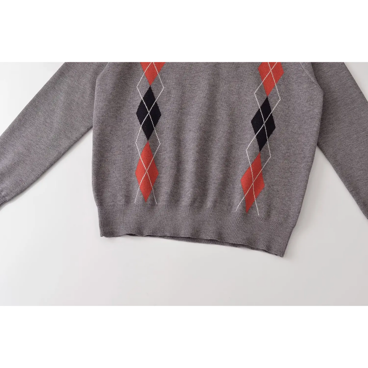 Close-up of ribbed hem and vertical argyle diamond columns