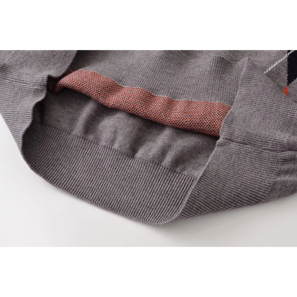 Close-up of hem underside showing reverse argyle knit in red and grey