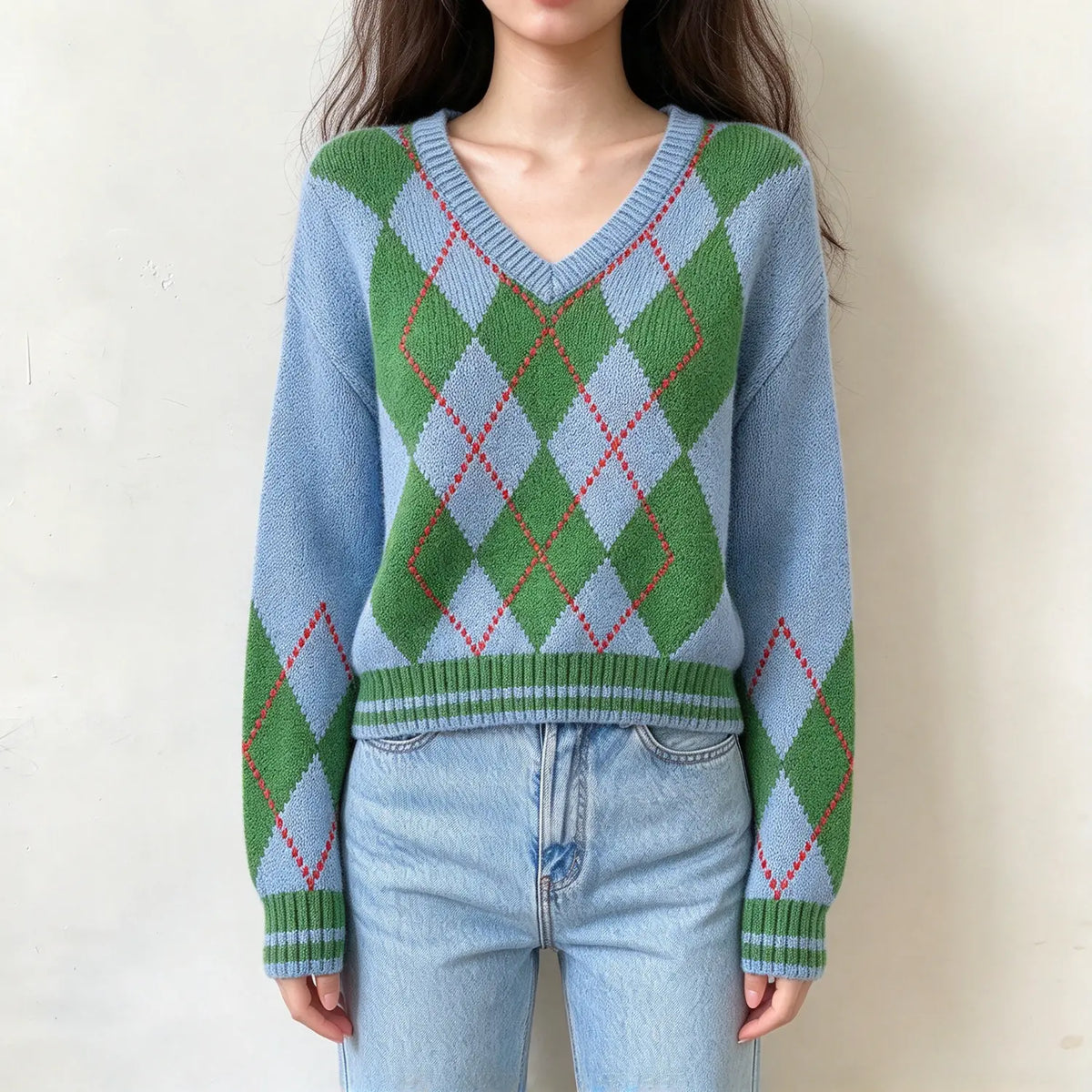 Model wearing light blue argyle v neck knit sweater, front view