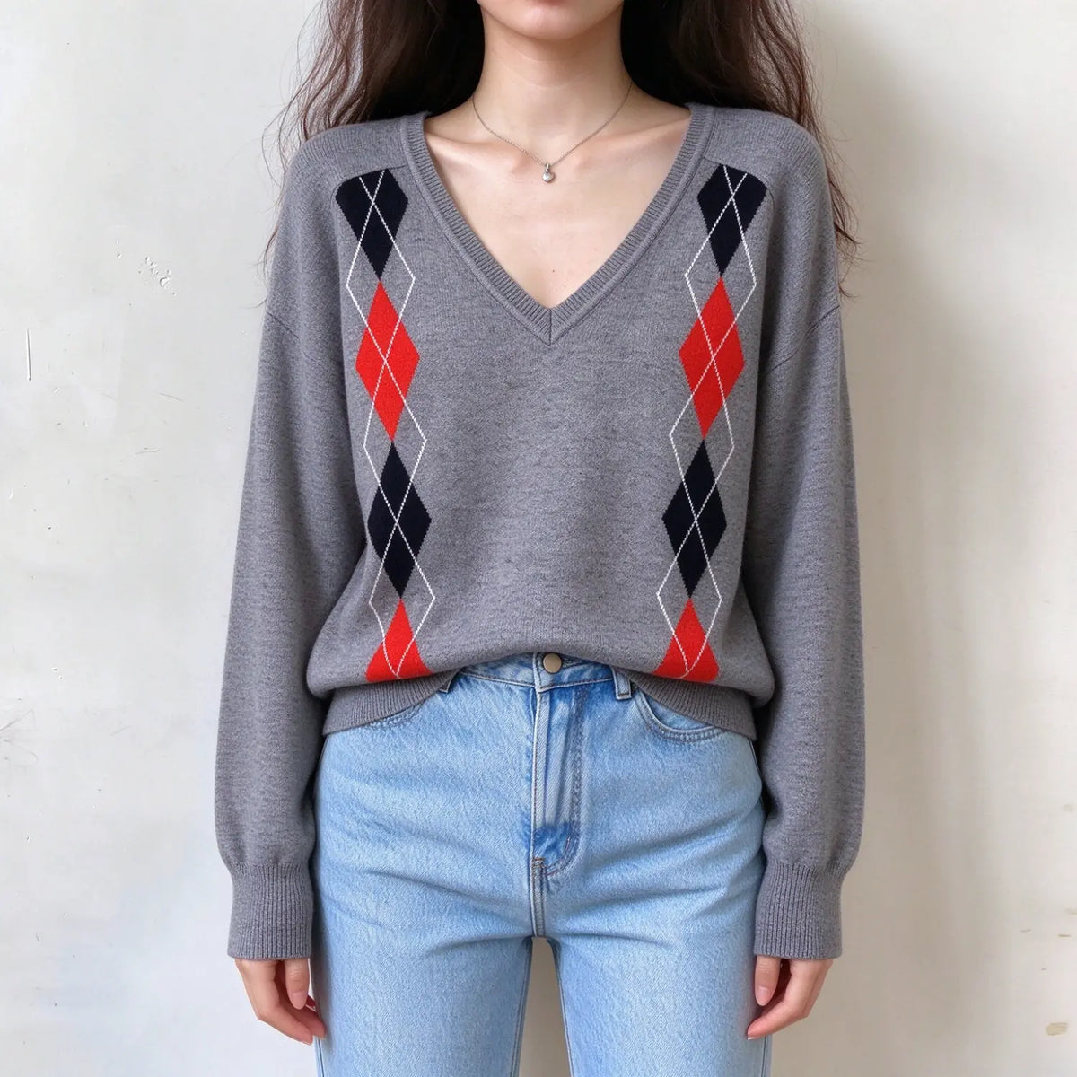 Model wearing grey argyle V neck knit sweater, front view