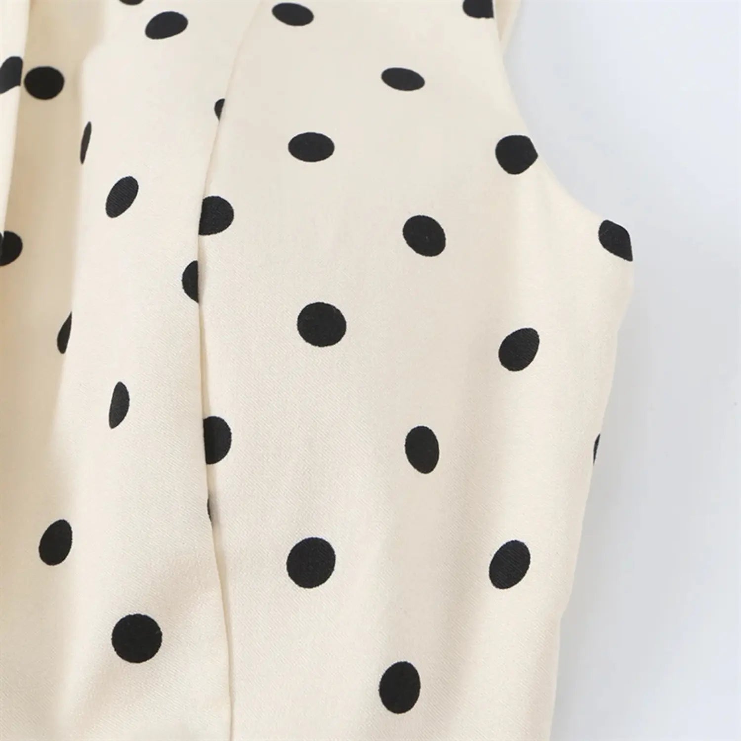 Side torso partial view, sleeveless armhole folded binding, vertical waist shaping darts, polka dot fabric drape