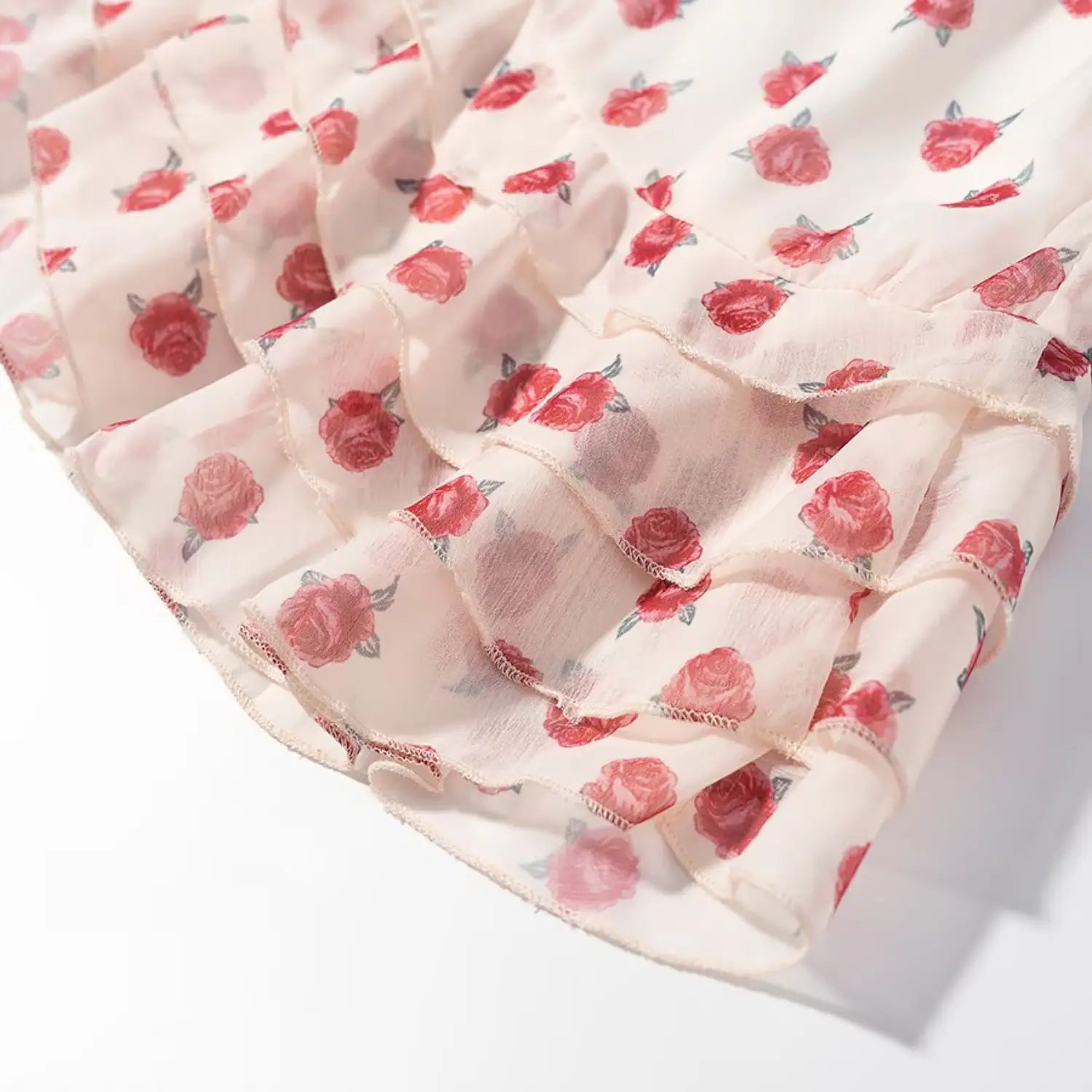 Skirt hem macro shot, multi-layer asymmetrical ruffle tier, sheer overlay chiffon with rose print