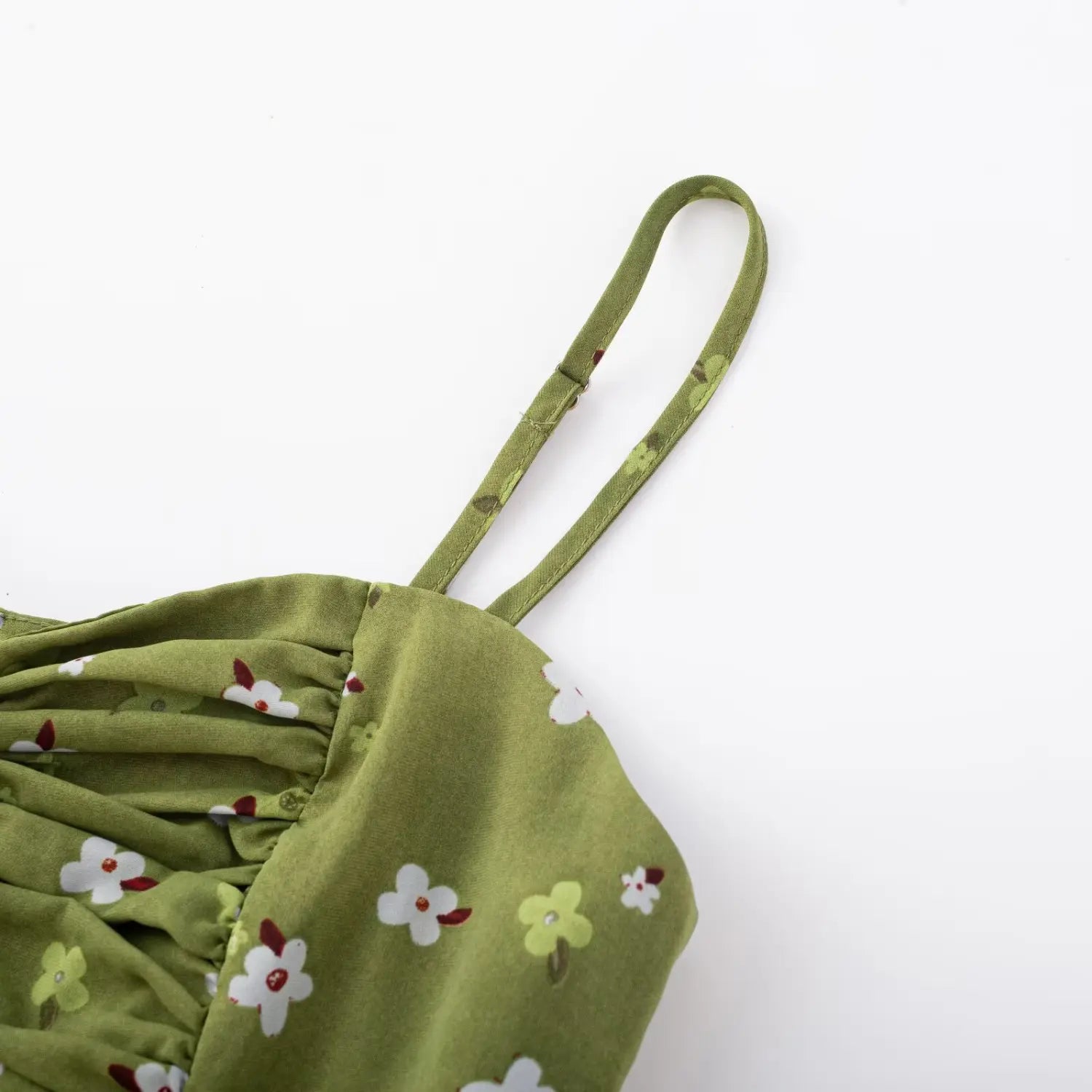 Avocado green tiny floral cami dress strap flat detail, matching printed adjustable buckle thin straps neck edge chiffon fabric white background shot