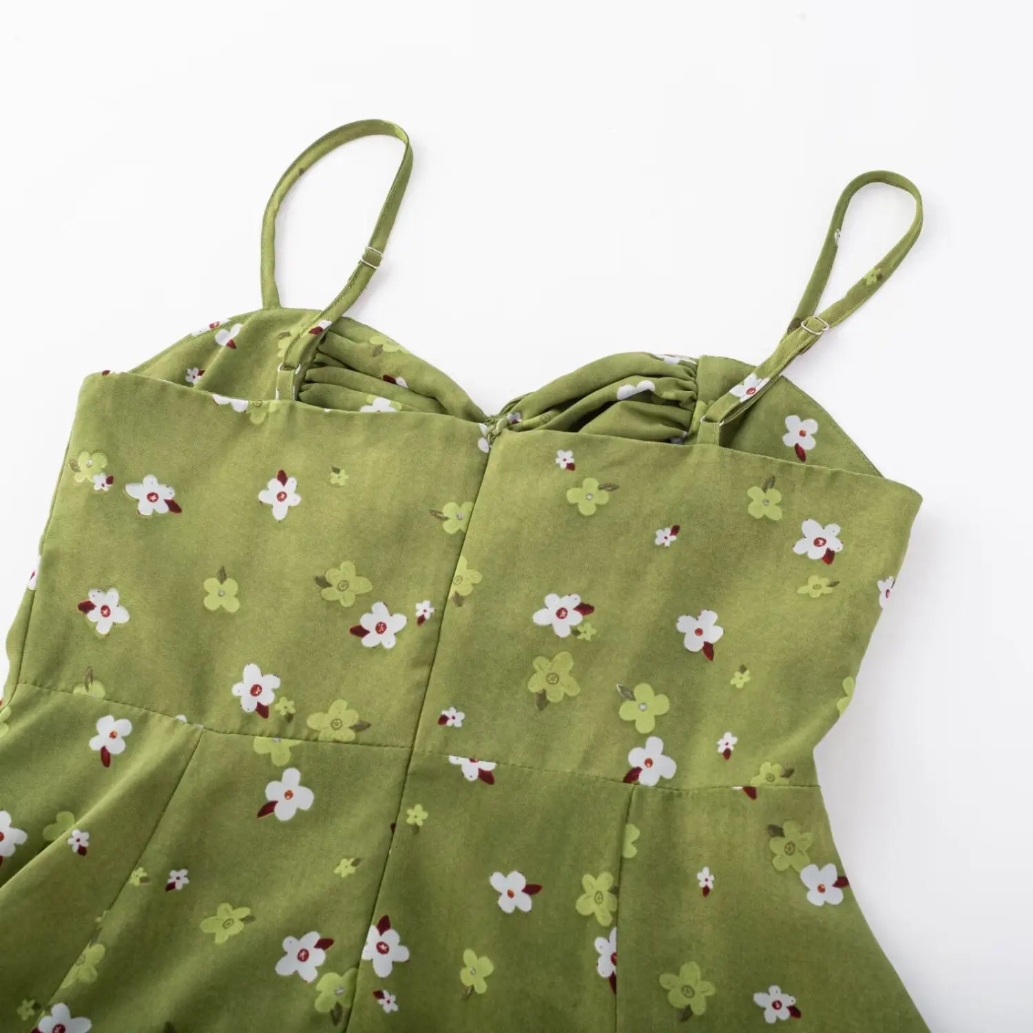 Avocado green tiny floral cami dress front flat lay, v-neck drawstring bust tie thin printed straps chiffon fabric white background photo