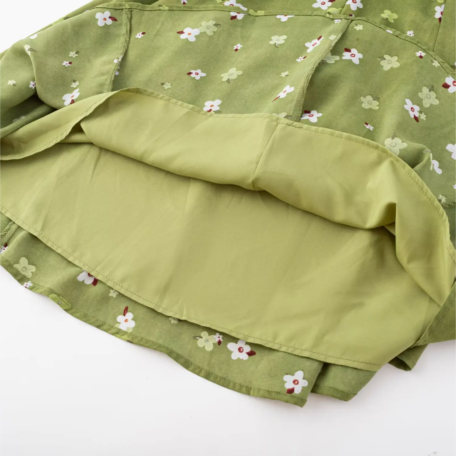 Avocado green tiny floral cami mini dress skirt flat close-up, double matching lining chiffon floral fabric overlock stitching white background shot