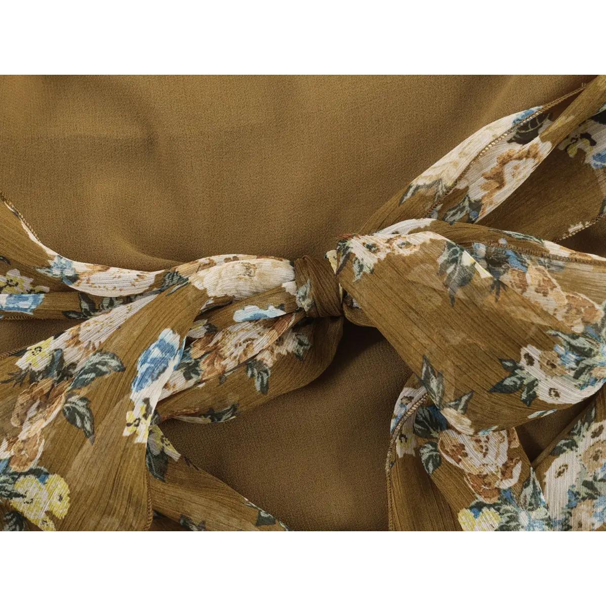 Close of oversized self-fabric printed bow tie for open back closure on vintage floral halter dress.